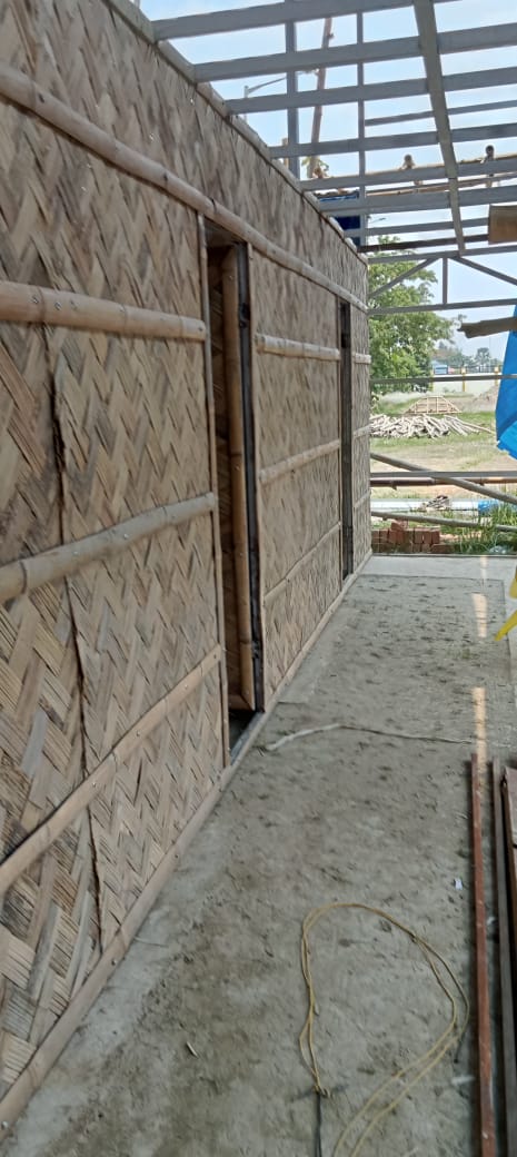Close-up of hand-woven bamboo panels in herringbone pattern, fitted to the steel frame with bamboo battens